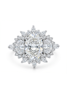 Diamond earring with a central pear-shaped diamond and smaller diamonds on a white background