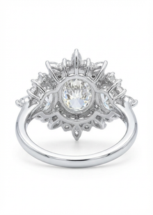 Diamond ring with a central gemstone and surrounding diamonds on a white background