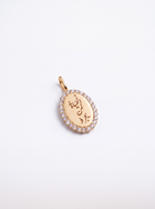 An oval gold pendant featuring engraved Arabic calligraphy and a border of small clear stones, photographed on a clean white background.