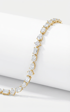 Gold bracelet with diamonds in different cuts on a white background