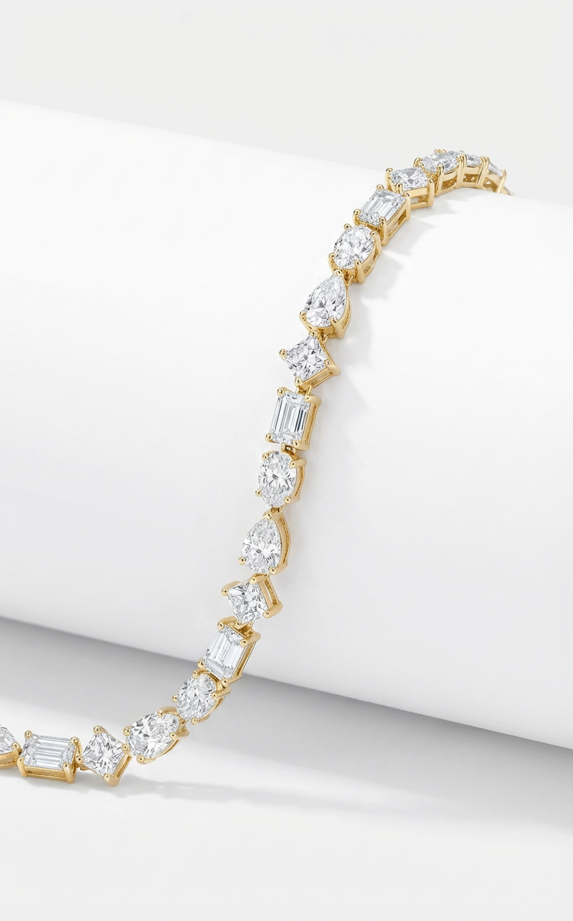 Gold bracelet with diamonds in different cuts on a white background