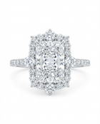 Diamond ring in white gold with a central radiant cut diamond with a diamond halo against a white background