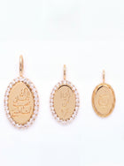 Three gold oval pendant charms with Arabic calligraphy, displayed in three different sizes on a plain white background. The two larger pendants are surrounded by a halo of small clear stones, and the smallest pendant on the right has a textured gold border.
