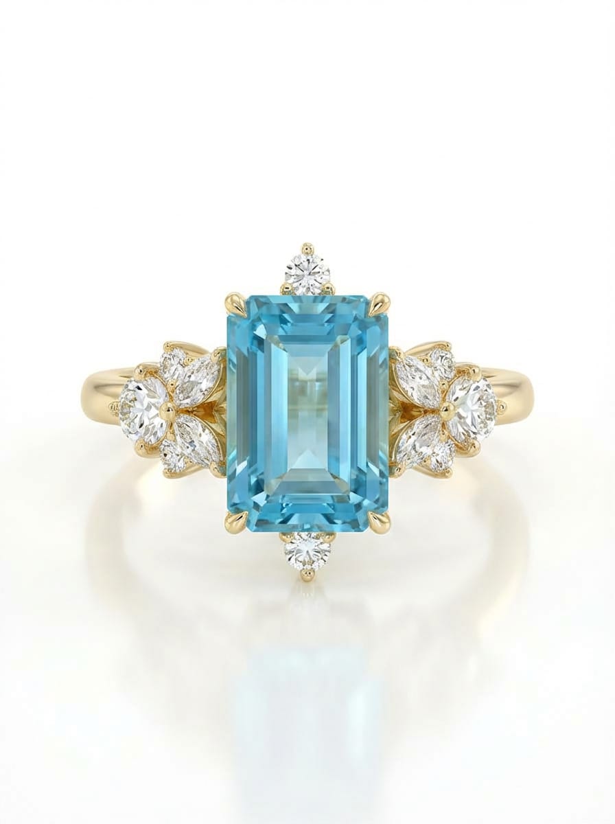 Gold ring with a blue gemstone and diamond accents on a white background