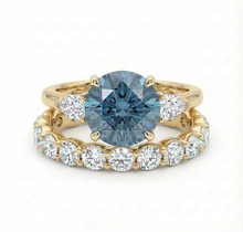 Gold ring with a blue gemstone and smaller diamonds on a white background