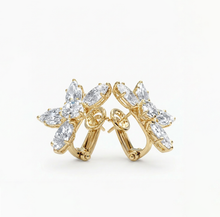 diamond floral Gold hoop earrings with clear gemstones on a white background
