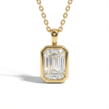 Gold necklace with a diamond pendant on a white background