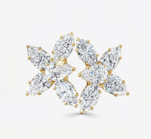Pair of diamond earrings on a light gray background