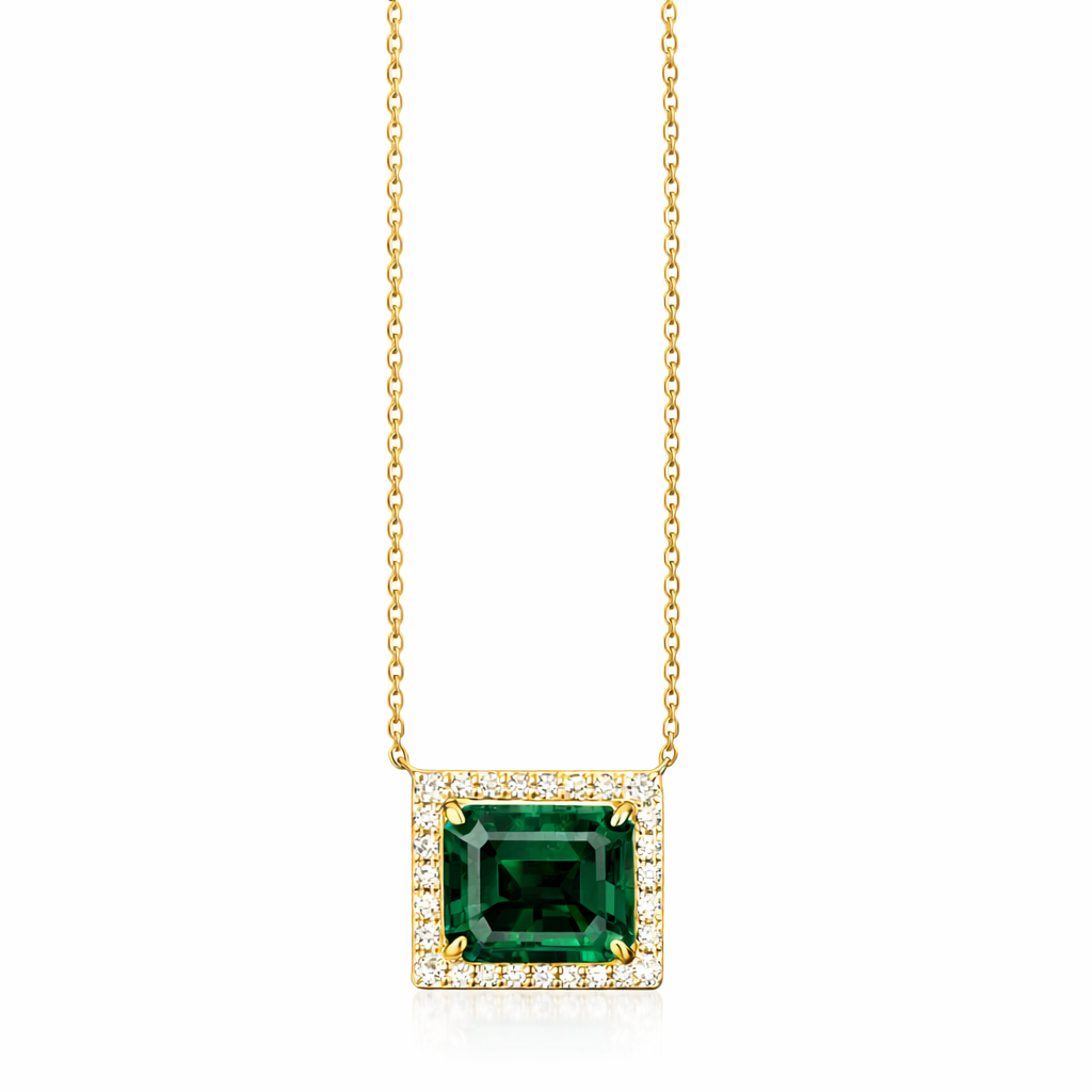 Gold necklace with a green gemstone pendant on a white background