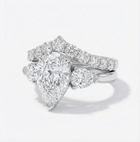 Diamond ring with a pear-shaped center stone on a white background