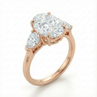 Rose gold ring with a large diamond and smaller diamonds on a white background