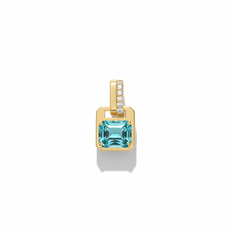 Gold pendant with a blue green gemstone on a white background