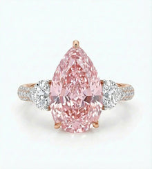 Pink diamond ring with rose gold and white gold band on a light gray background