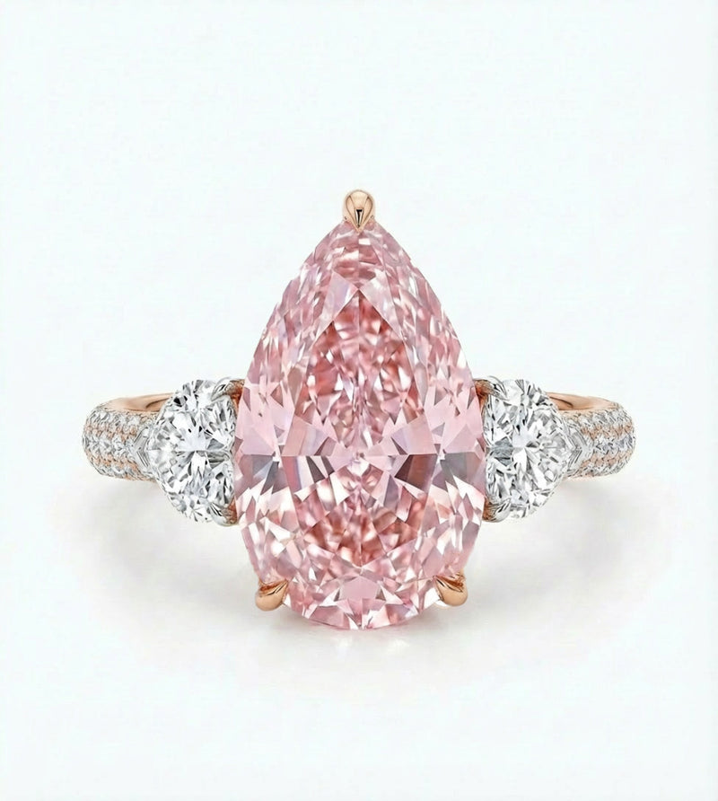 Pink diamond ring with rose gold and white gold band on a light gray background