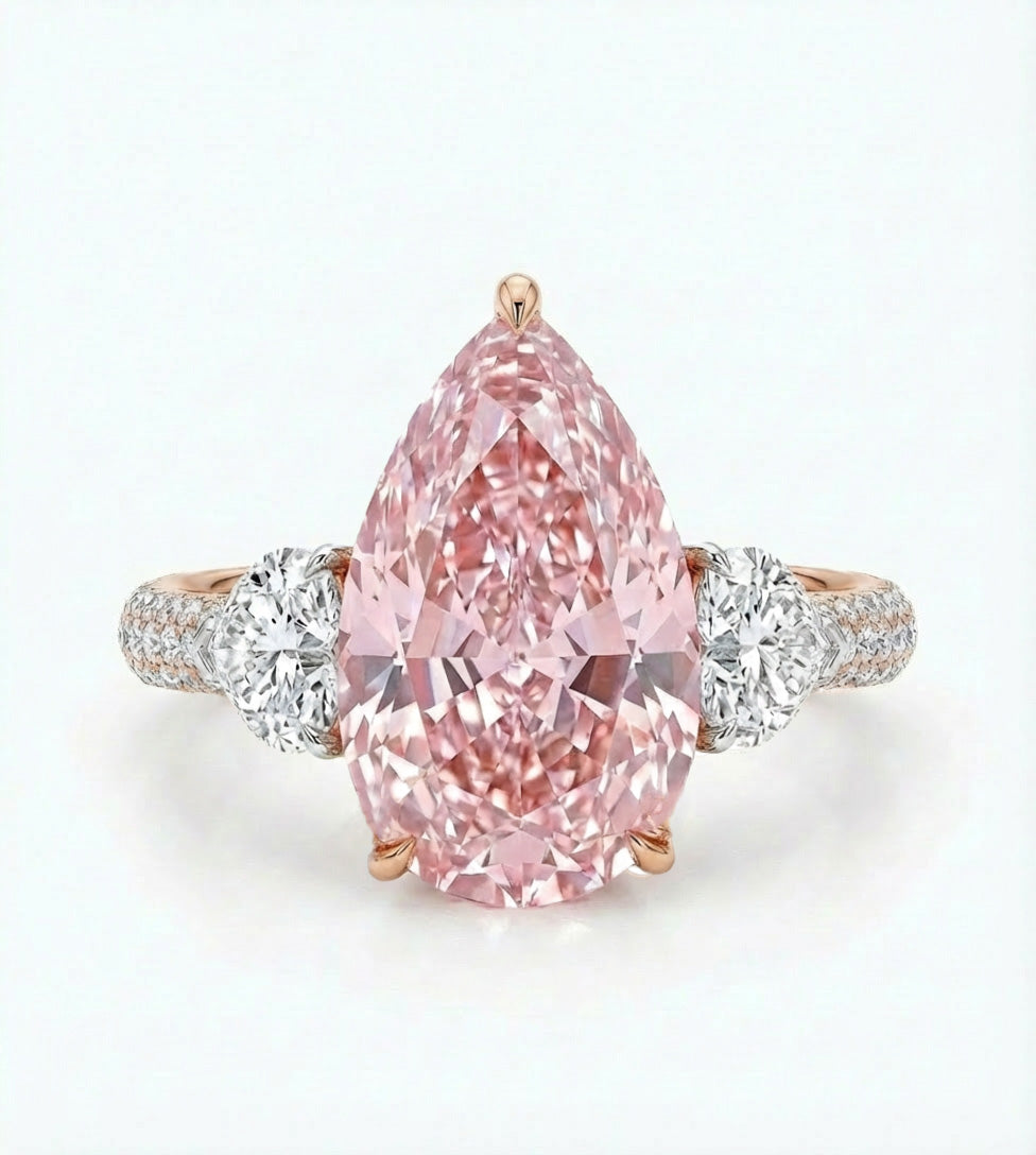Pink diamond ring with rose gold and white gold band on a light gray background