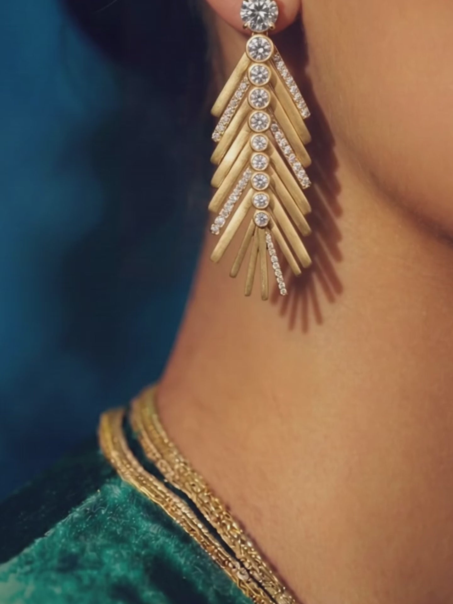 video of gold and diamond palm leaf earring moving in the wind 