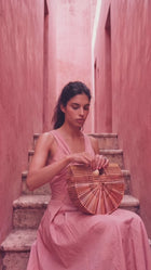 video of model wearing a pink diamond ring and eating strawberries and carrying a fashionable straw handbag 