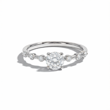 Silver ring with a central diamond and smaller stones on a white background
