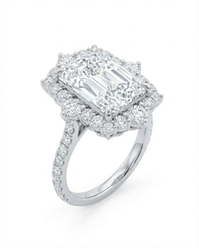 Diamond ring with a prominent radient-cut center stone on a white background