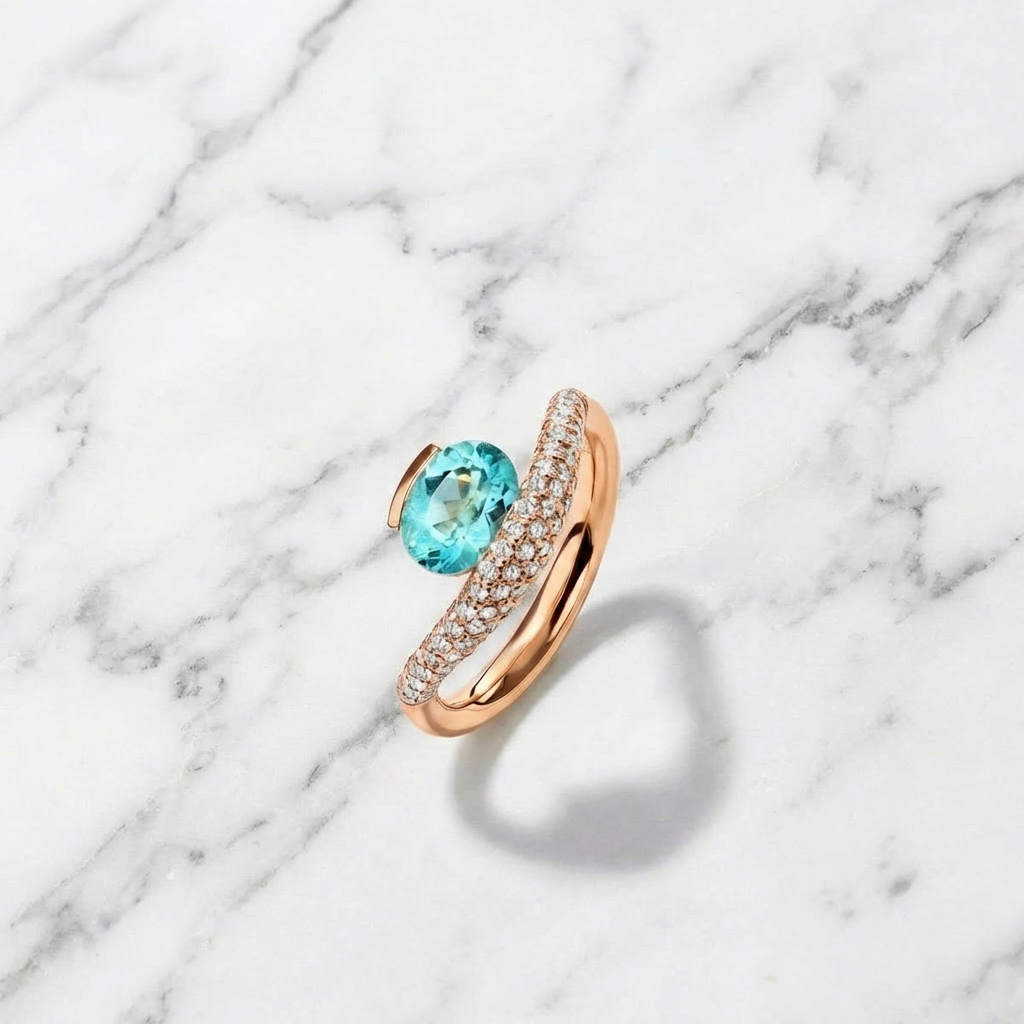 Gold ring with a blue gemstone on a marble background