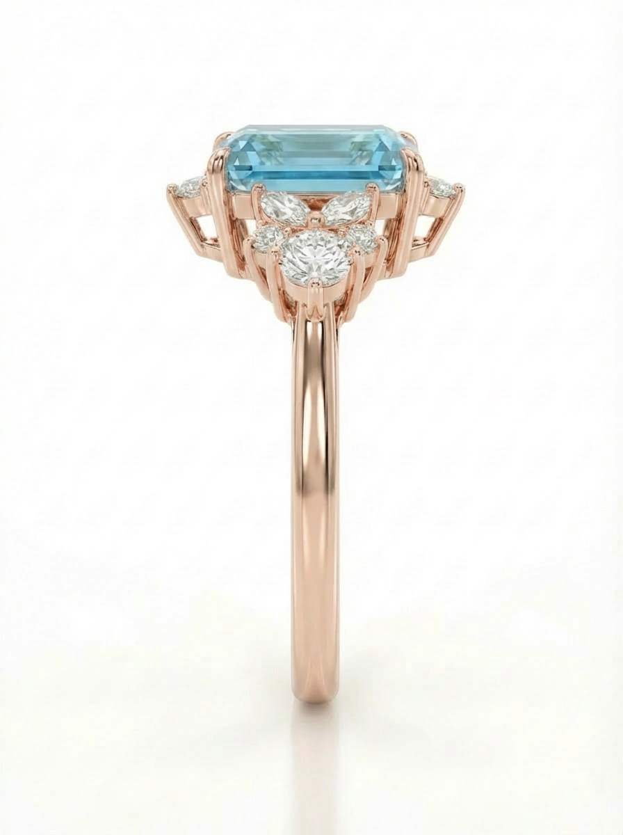 Rose gold ring with a blue gemstone and smaller diamonds on a white background