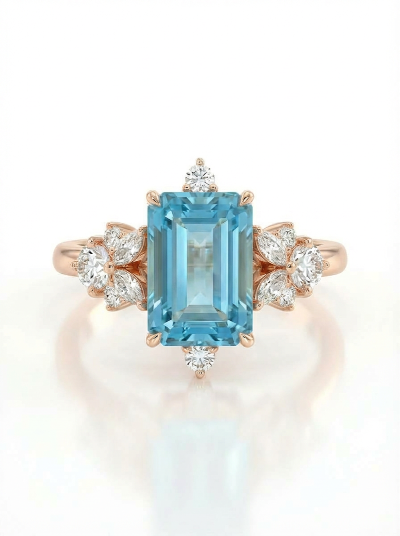 Ring with a blue gemstone and rose gold setting on a white background