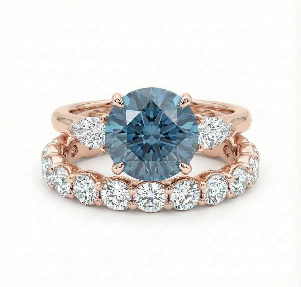 blue diamond ring and white diamond wedding band both set in rose gold