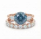 blue diamond ring and white diamond wedding band both set in rose gold