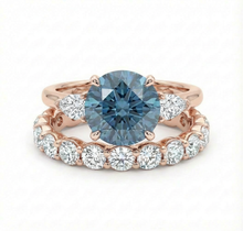 blue diamond ring and white diamond wedding band both set in rose gold