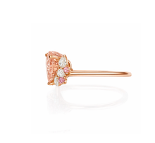 Rose gold ring with pink gemstone on a white background