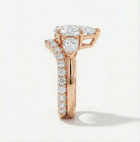 Rose gold ring with a diamond heart and surrounding diamonds on a light background