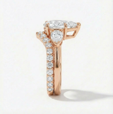 Rose gold ring with a diamond heart and surrounding diamonds on a light background