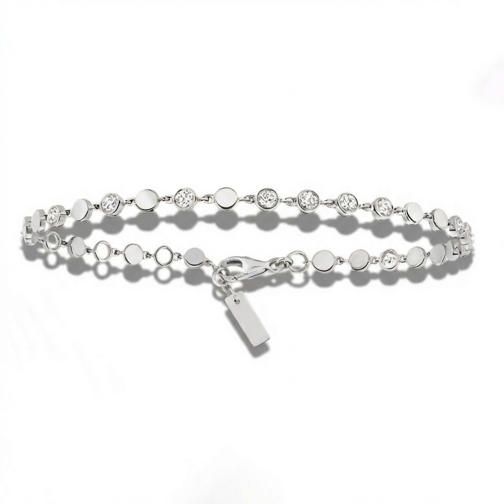 Silver bracelet with small round beads on a white background
