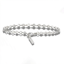Silver bracelet with small round beads on a white background