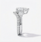 Diamond ring with a heart-shaped center stone on a white background