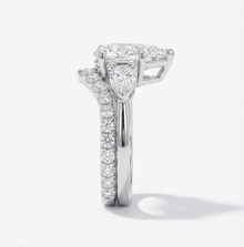 Diamond ring with a heart-shaped center stone on a white background