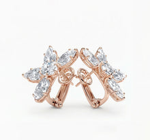 side view of rose gold earrings with diamonds on a white background