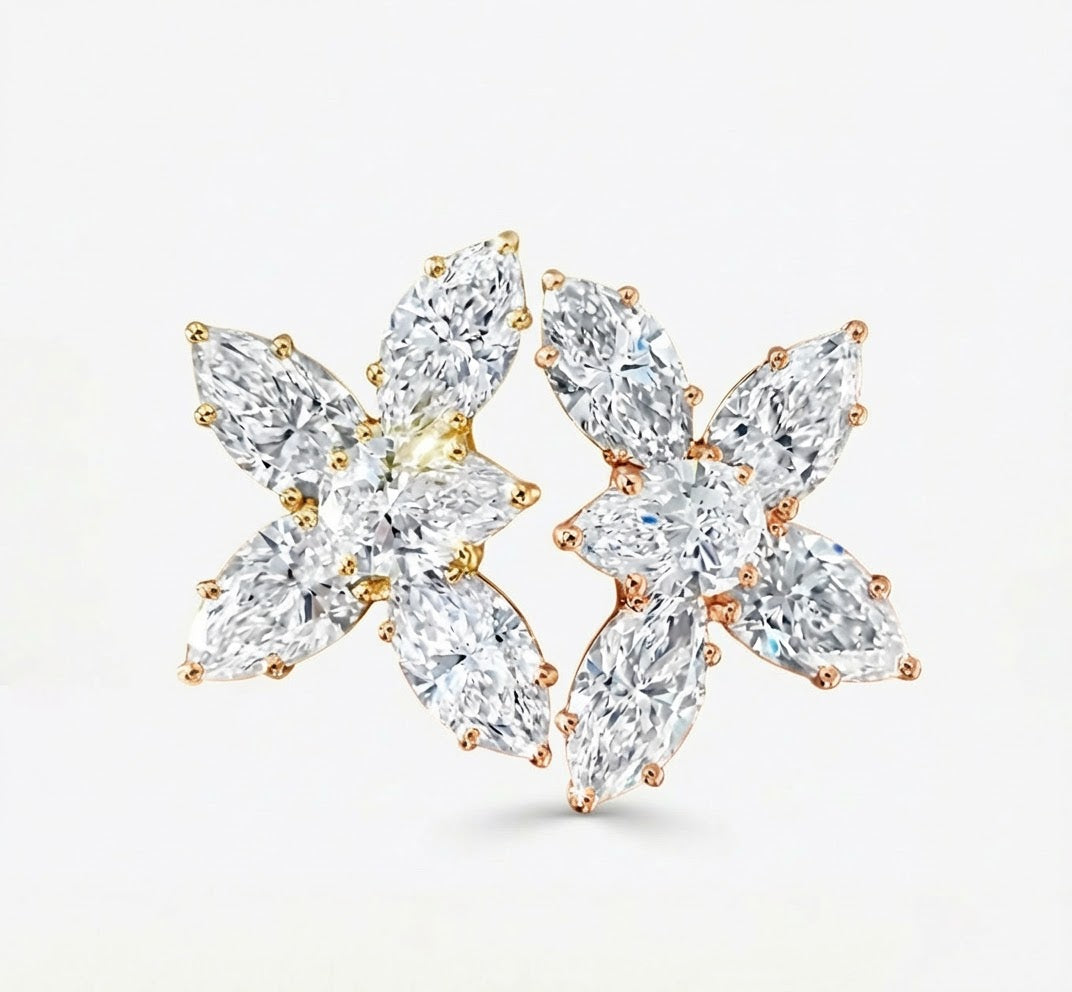Pair of floral diamond earrings on a white background