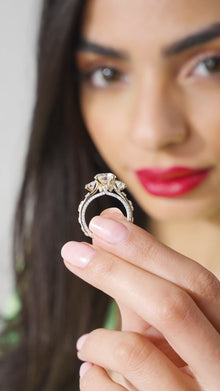 Woman holding a diamond ring close to her face